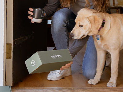 A person picking up a Verve Coffee box at their front door