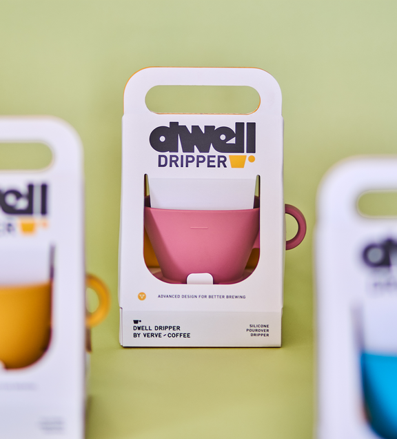 a pink and yellow mug in a white box