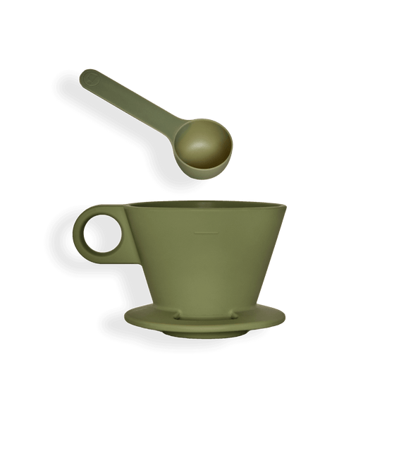 a green teacup with a spoon