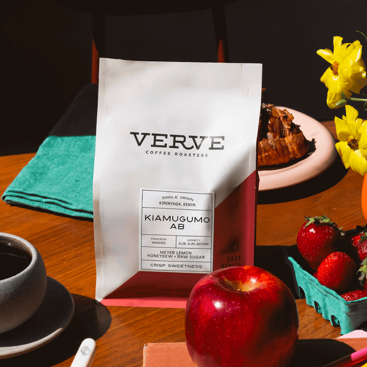 a bag of coffee and fruit on a table