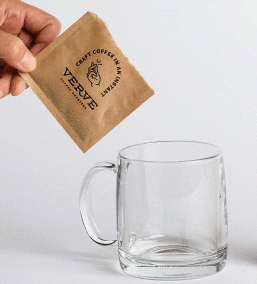 Instant Coffee packet being poured into a mug