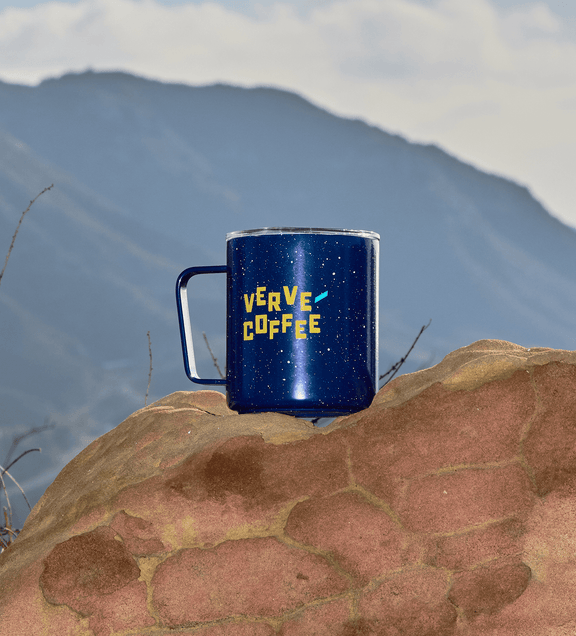 a blue mug on a rock